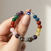 9 Multicolored beaded bracelet held by a hand against a neutral background