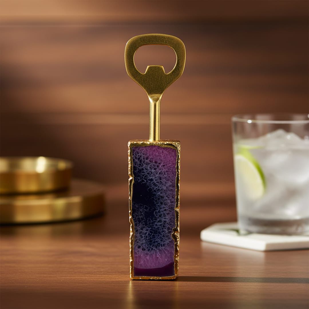 Decorative bottle opener with purple and gold design on a wooden surface.