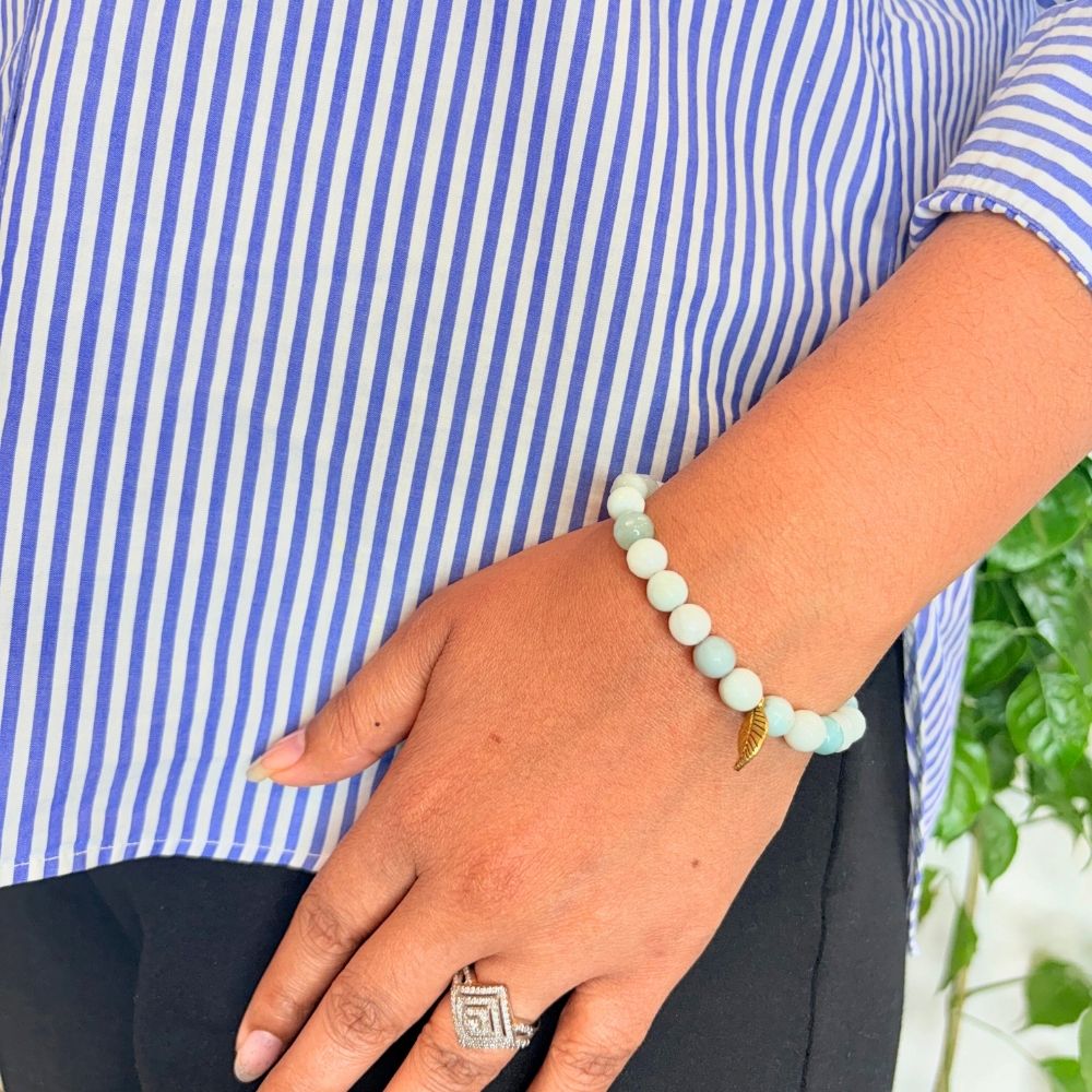 woman wearing a Amazonite Crystal bracelet on her left hand