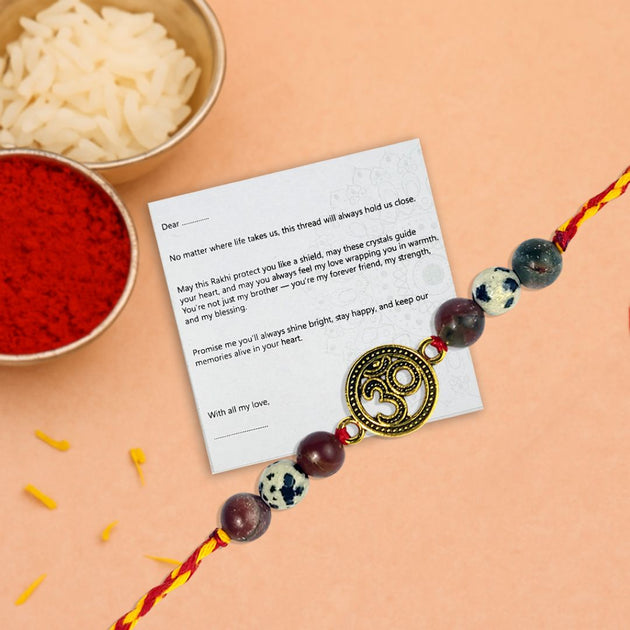 Rakhi with a message card on a peach background