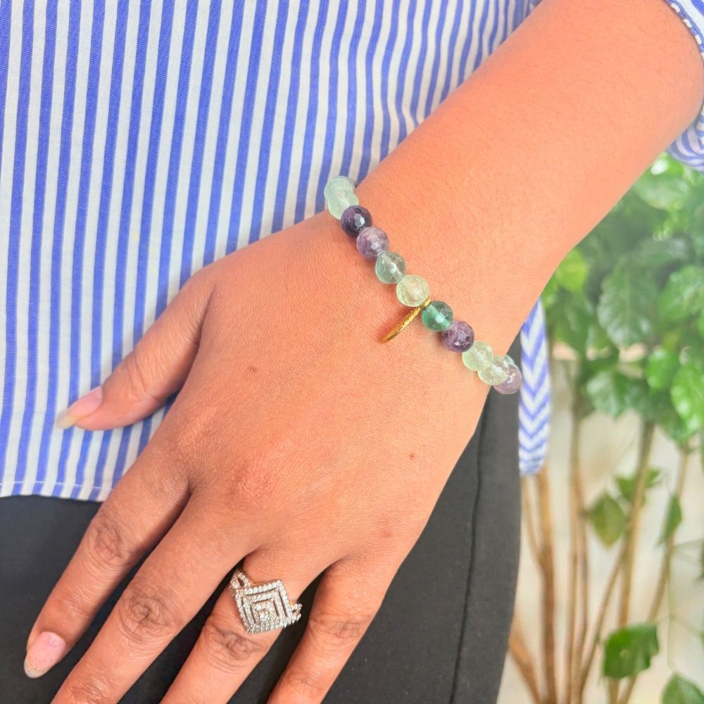 woman wearing a Fluorite Crystal bracelet on her left hand