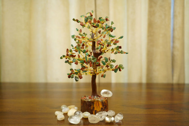 Green Aventurine Red Jasper Crystal Tree surrounded by white pebbles