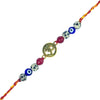 Decorative rakhi string with beads and a gold Om symbol charm on a white background
