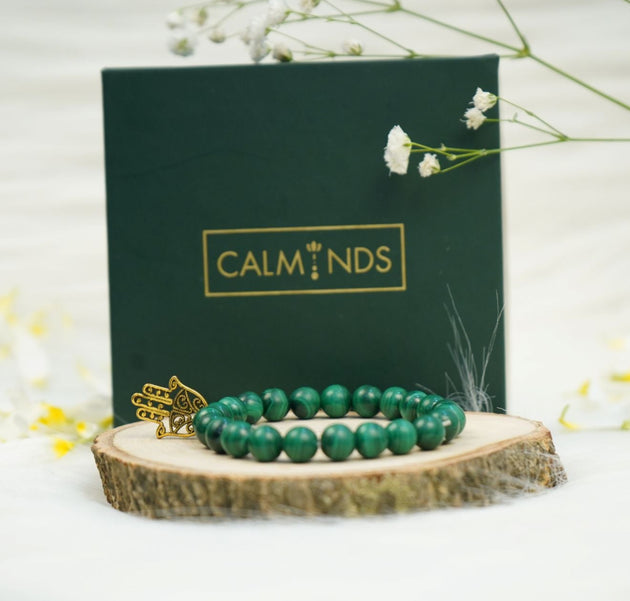 Green Malachite Healing Bracelet with golden charm with a box behind