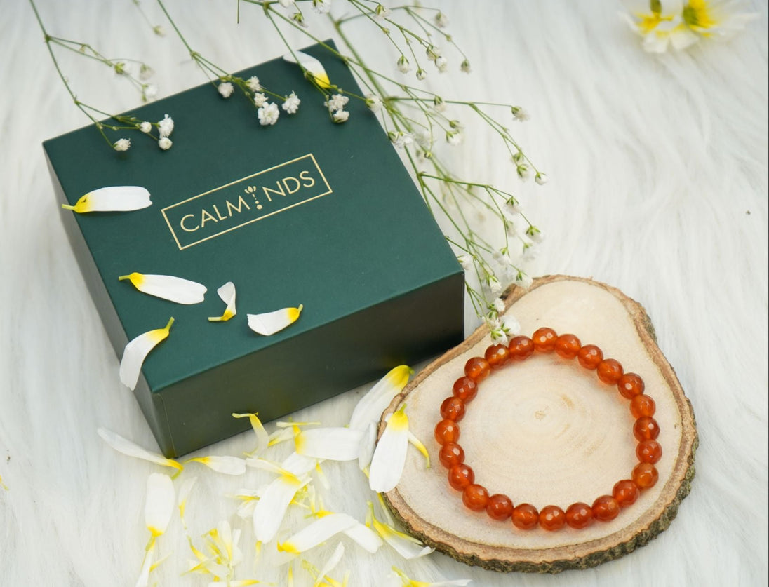 Natural Carnelian Crystal Bracelet of orange color with a box next to it