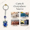 Keychain with blue evil eye design and text 'Carry It Everywhere You Go' on a light background.
