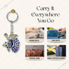 Keychain with peacock design on a white background, with text 'Carry It Everywhere You Go' and images of keychain use cases.