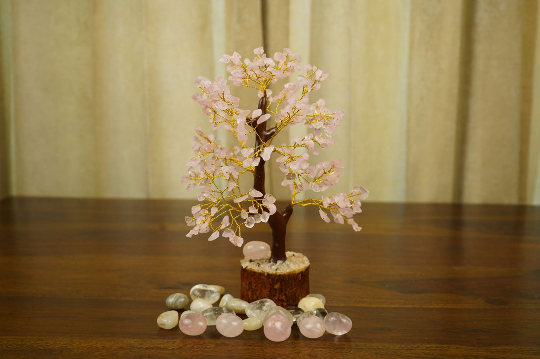 Rose Quartz Crystal Tree surrounded by pebbles 