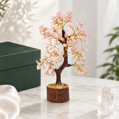 Rose Quartz Crystal Tree with pale pink stone chips on a wooden log base