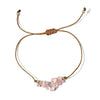 bracelet with pink stone beads and gold thread on a white background