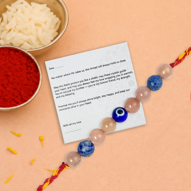 Rakhi with a card on a peach background