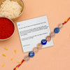 Rakhi with a card on a peach background