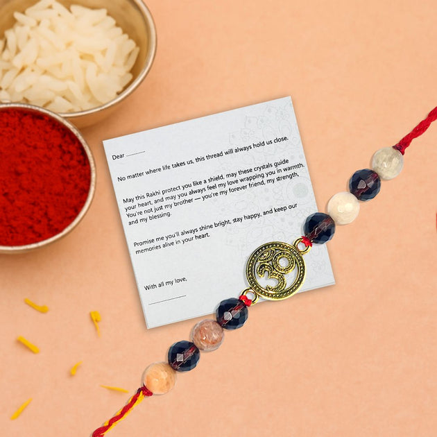 Rakhi with a message card on a peach background
