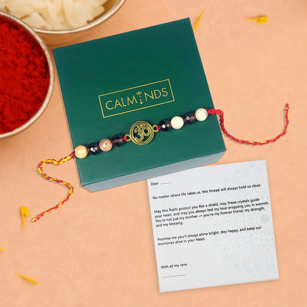rakhi with stones on a green box labeled 'Calminds' on a beige background