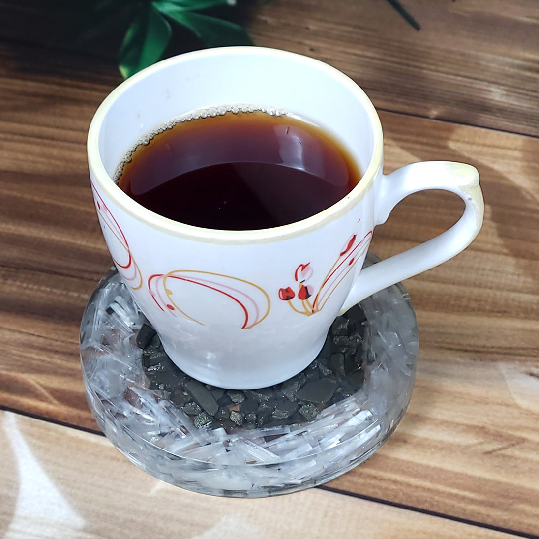 pyrite sri yantra orgonite coaster with a cup on top