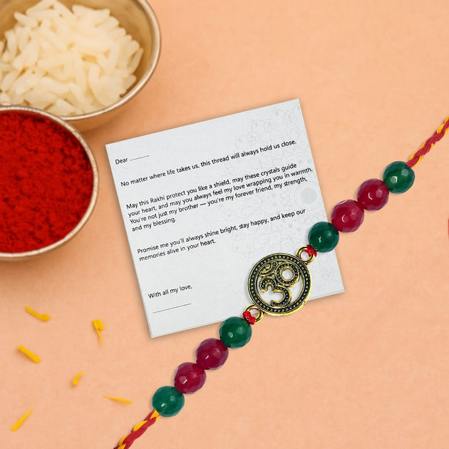 Rakhi with a message card on a peach background