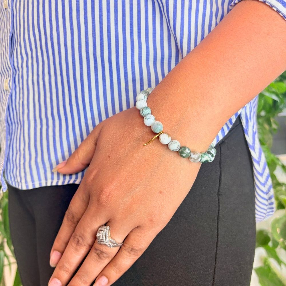 woman wearing a Tree Agate Crystal bracelet on her left hand