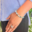 woman wearing a Tree Agate Crystal bracelet on her left hand