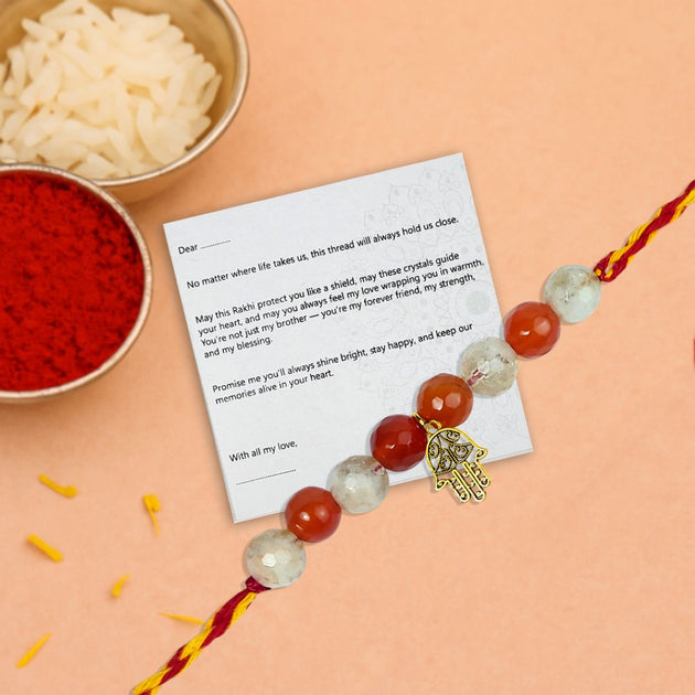 Decorative rakhi with beads and a card on an orange background