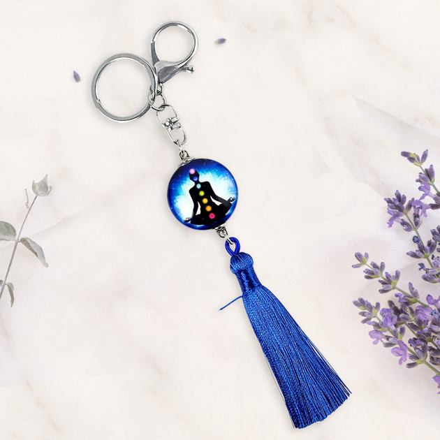 Keychain with blue tassel and decorative bead on a light background