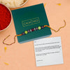 Rakhi with beads on a 'Calminds' box with a card on a peach background