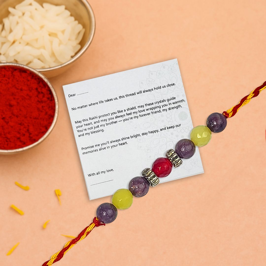 Rakhi with a card on a peach background