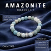 Amazonite bracelet on a dark fabric background with Calminds branding.