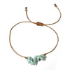 Bracelet with amazonite stones and gold accents on a white background