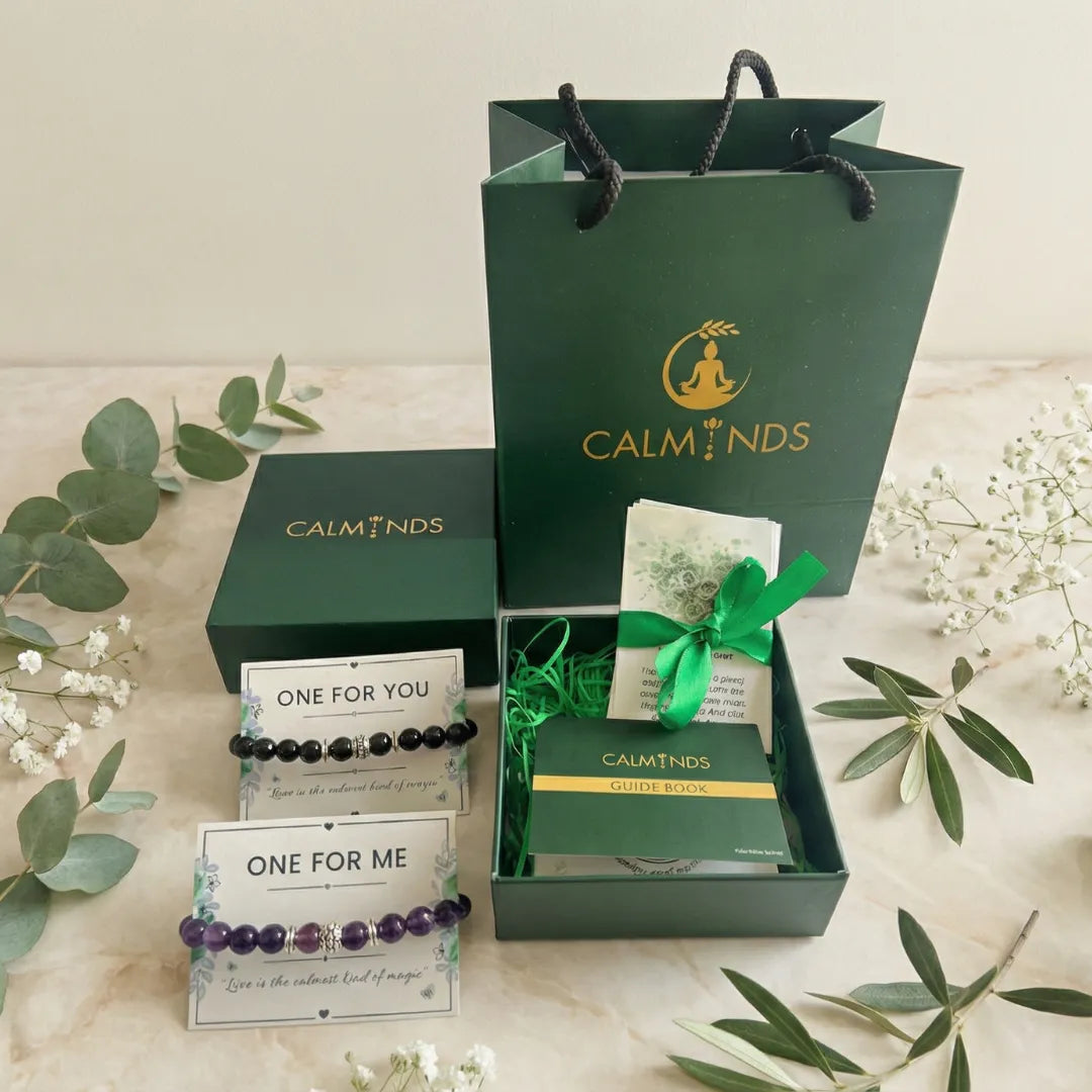 Green 'CALMINDS' packaging with bracelets and a card on a light background