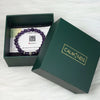 Green box with a purple beaded bracelet and 'Calminds' branding on a white background