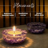 Two purple candle holders with a lit candle on a wooden surface, labeled for bedroom, meditation corner, and study/office desk placements.