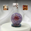 Decorative purple sphere with spiral design on a white surface, with examples of its use on a bedside table, work desk, and healing altar.
