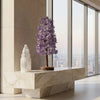 Modern interior with a marble console table featuring decorative items and cityscape view.