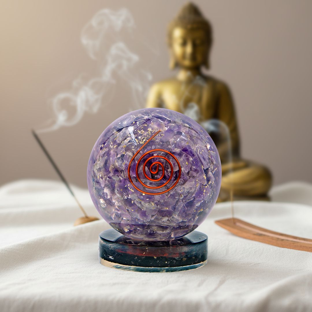 purple amethyst orgonite ball on black tourmaline stand