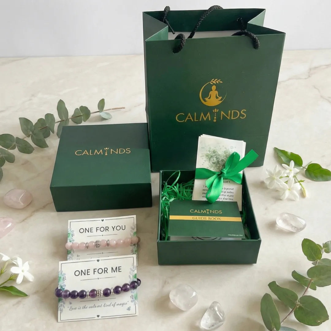 Calminds product packaging with green box, card, and bracelet on a light background