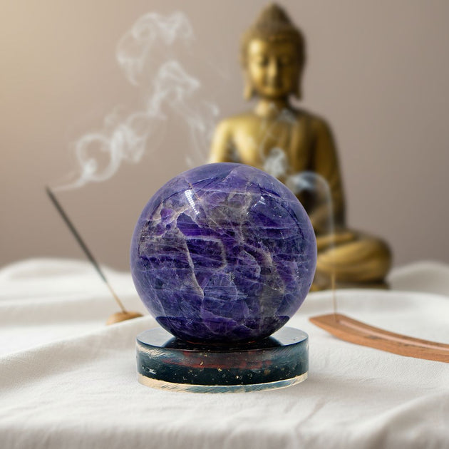 amethyst mini crystal ball on a black tourmaline stand