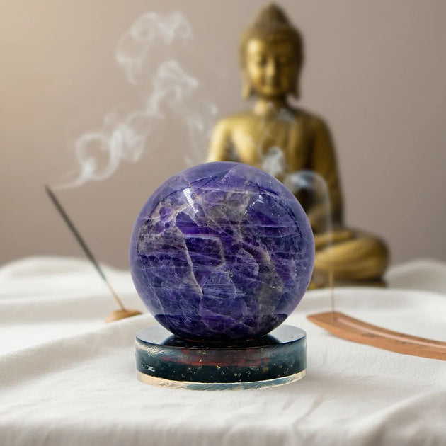 amethyst mini crystal ball on a black tourmaline stand