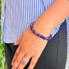 woman wearing a Amethyst Crystal bracelet on her left hand