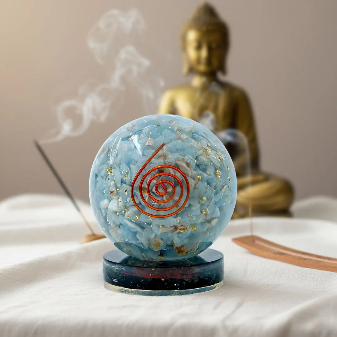 sky blue color angelite orgonite ball on a black tourmaline stand