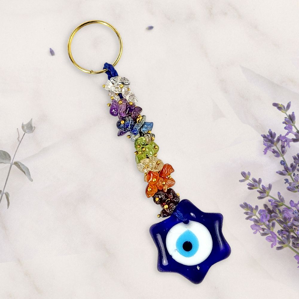Colorful beaded keychain with an evil eye charm on a light background