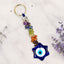 Colorful beaded keychain with an evil eye charm on a light background