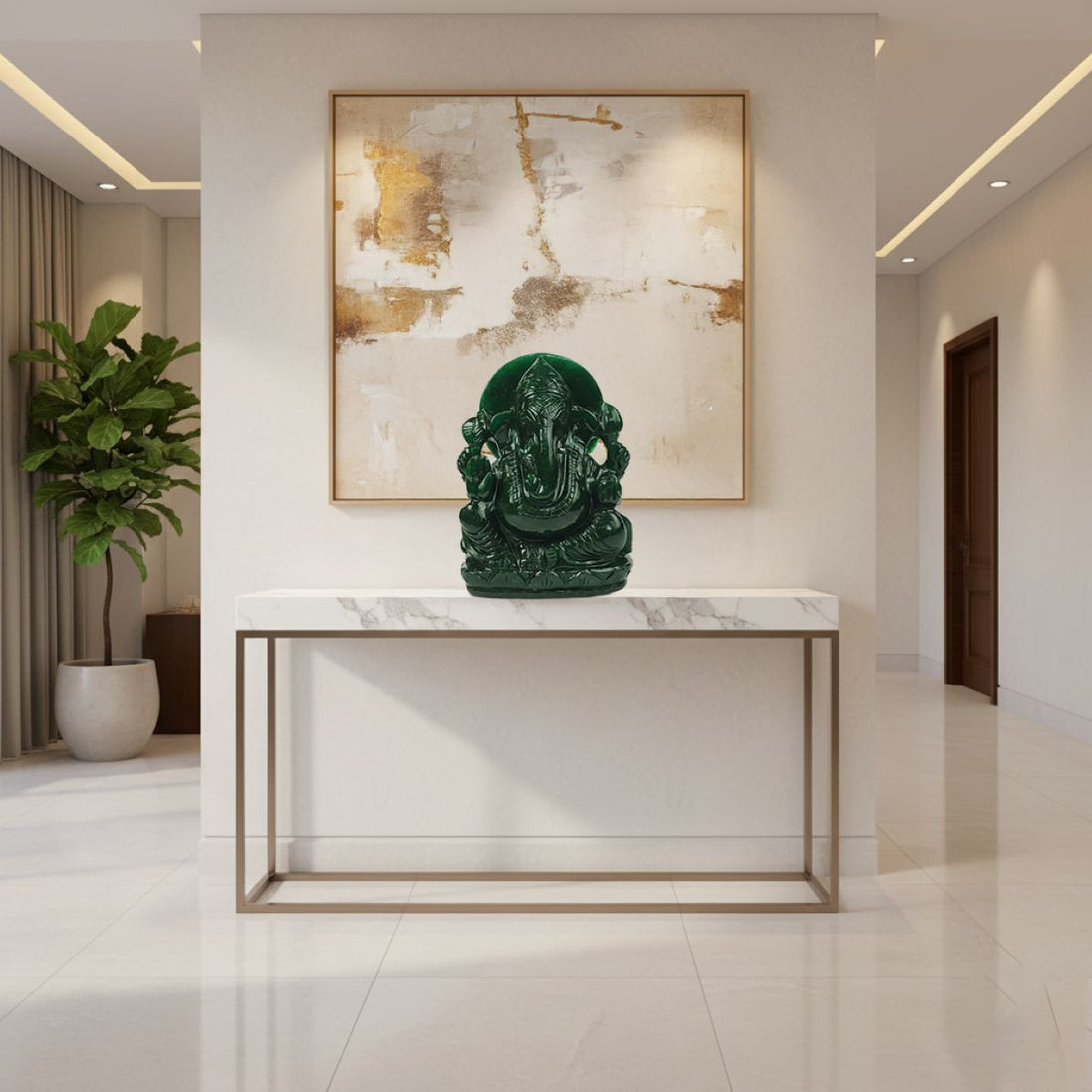 Green jade ganesha statue on a marble table in a modern interior setting with abstract art on the wall.