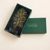 Decorative tree in a green box with 'Calm Minds' branding on a beige background
