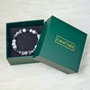 Open green box with a bracelet inside, featuring the brand 'CALM NDS'.