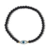 Black beaded bracelet with an eye-shaped charm on a white background