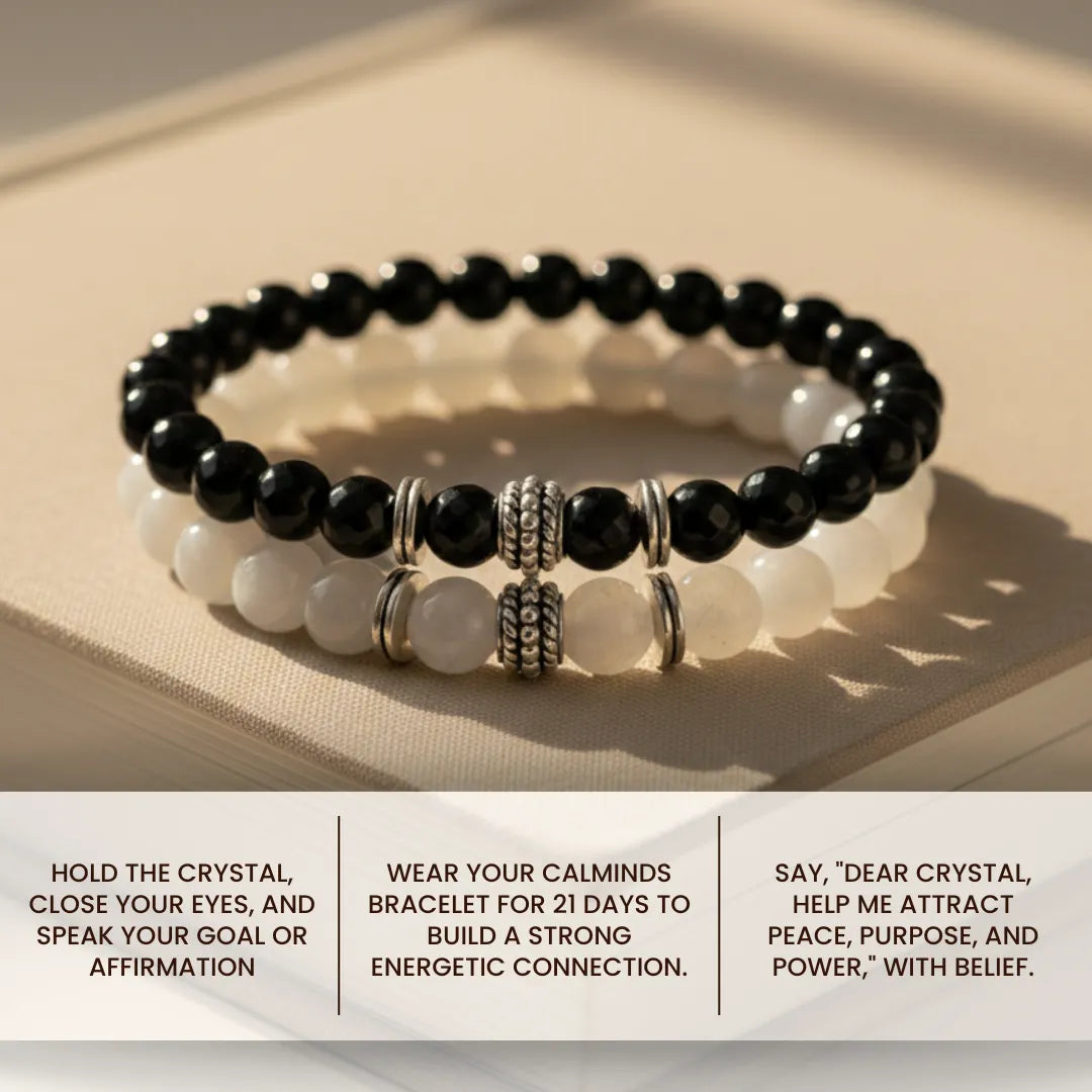 Black and white beaded bracelet with silver accents on a beige surface, accompanied by usage instructions.