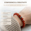 Carnelian crystal bracelet on a wrist with text about its benefits on a light background