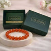 Carnelian bracelet on a white stand with 'Calminds' branded box and guide book in the background.