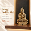 Golden pyrite Buddha idol seated in meditation on a wooden shelf