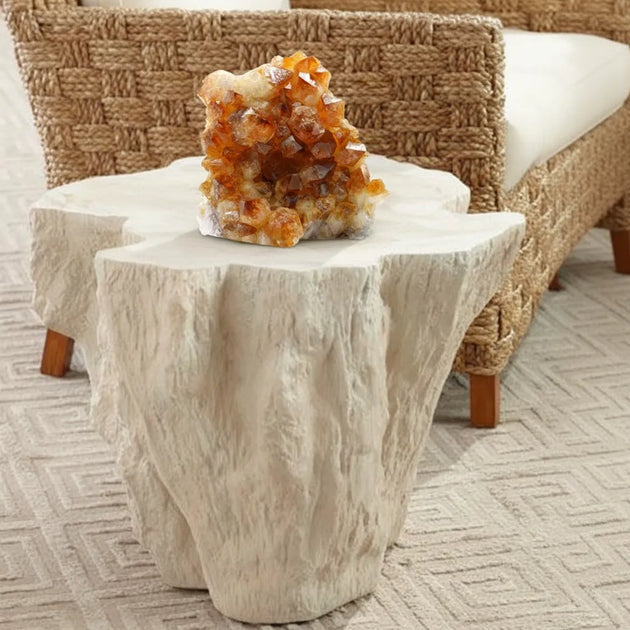 Decorative stone table with a crystal formation on top in a living room setting.